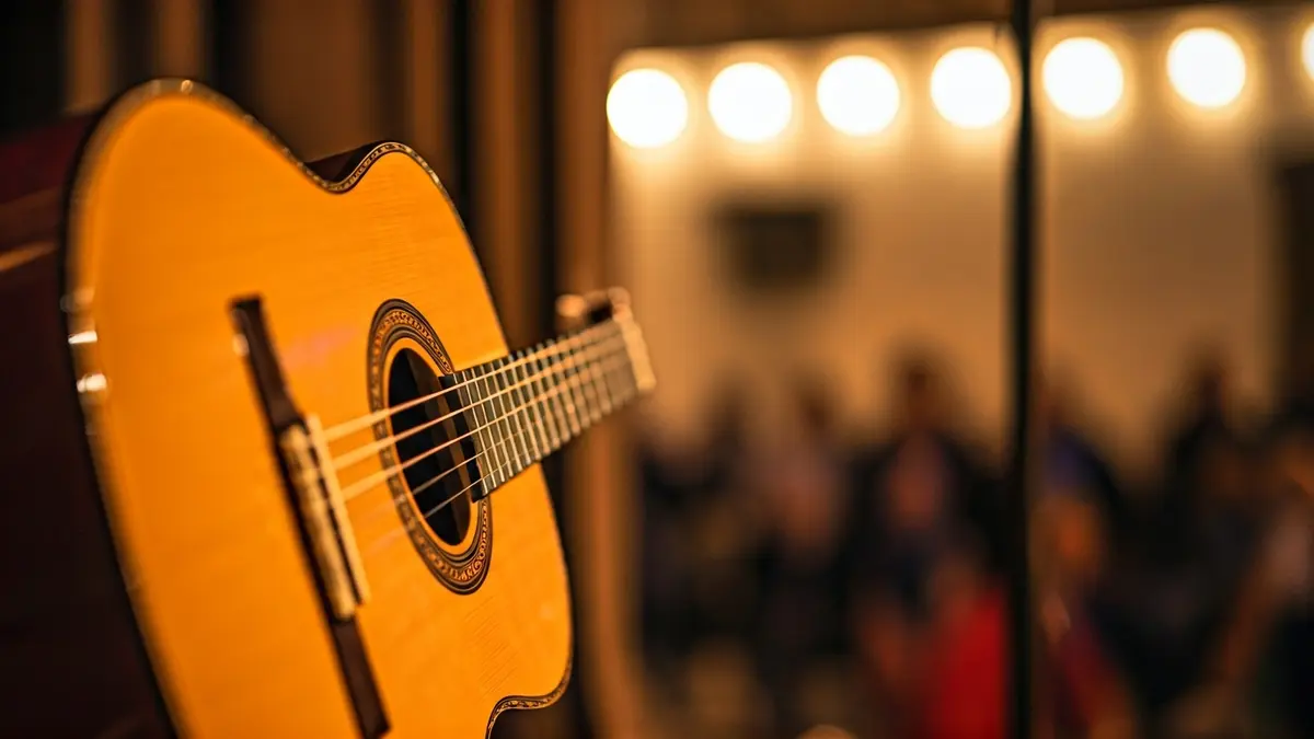 Generic image of a flamenco guitar with a microphone in the background, evoking a performance.
