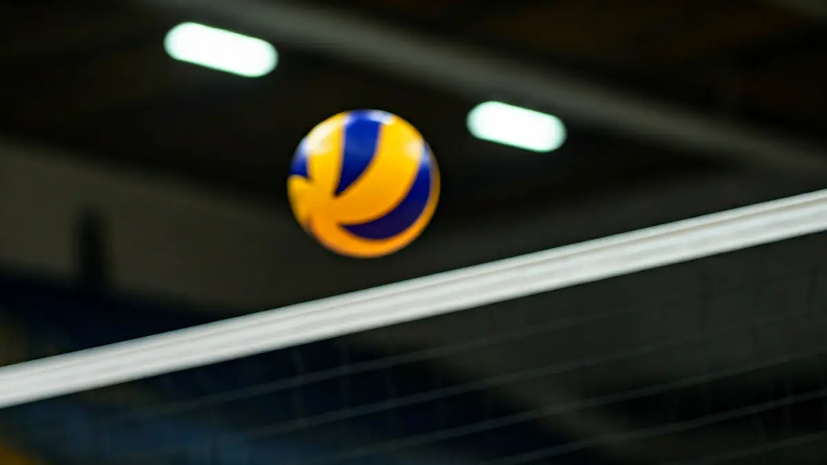 Generic image of a volleyball net with a ball in mid-air.