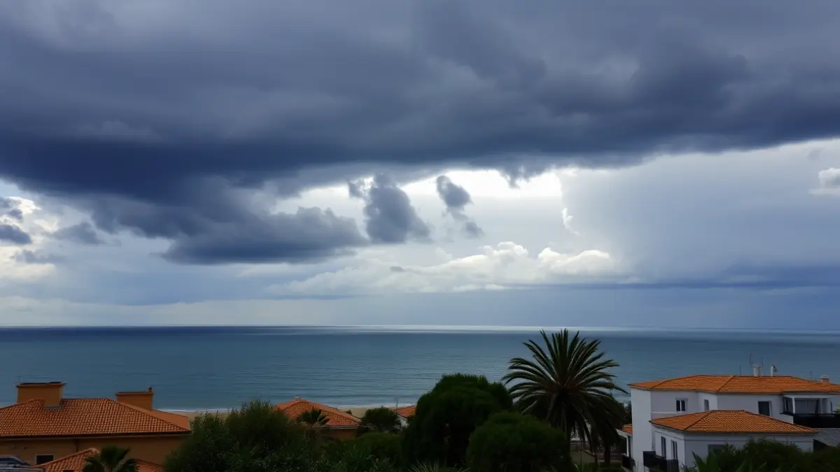 Dramatic sky over the coast of Cádiz, with dark clouds and a hint of rain, contrasting with a sunny foreground.
