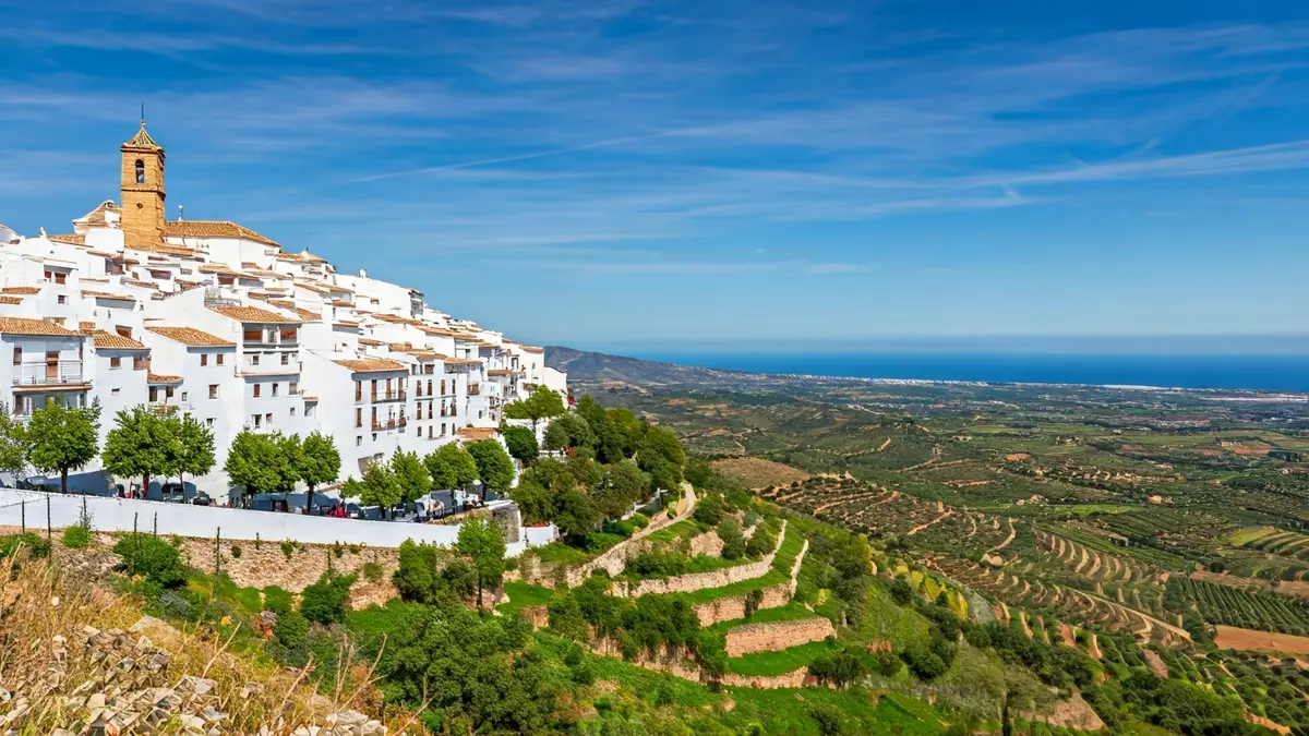 Panoramic view of Casares, a white Andalusian village nestled between mountains and the sea.