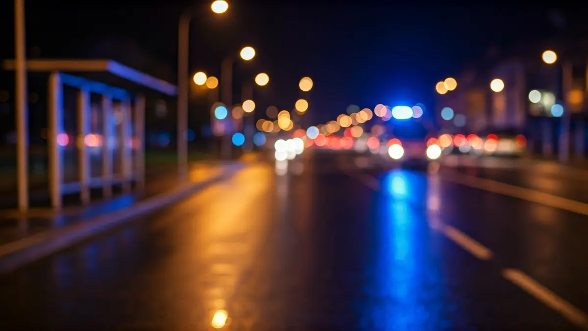 Generic image of emergency lights reflected on wet asphalt at night.