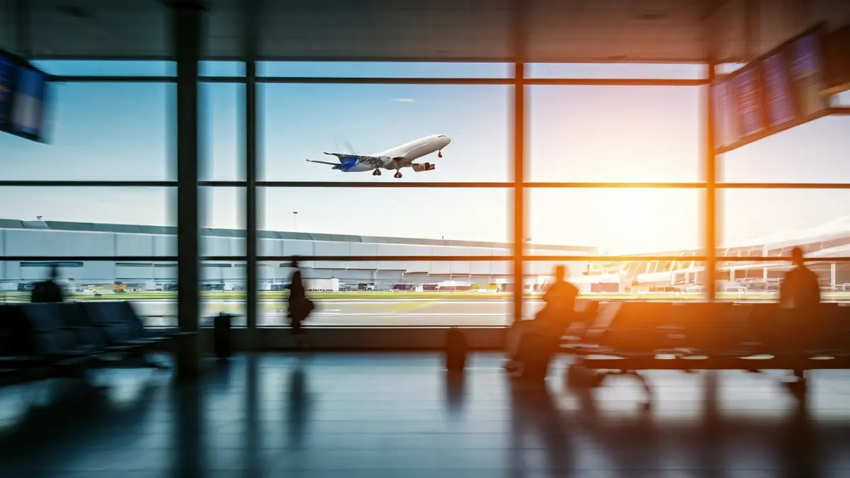 Generic image of an airport with passengers and a plane taking off.