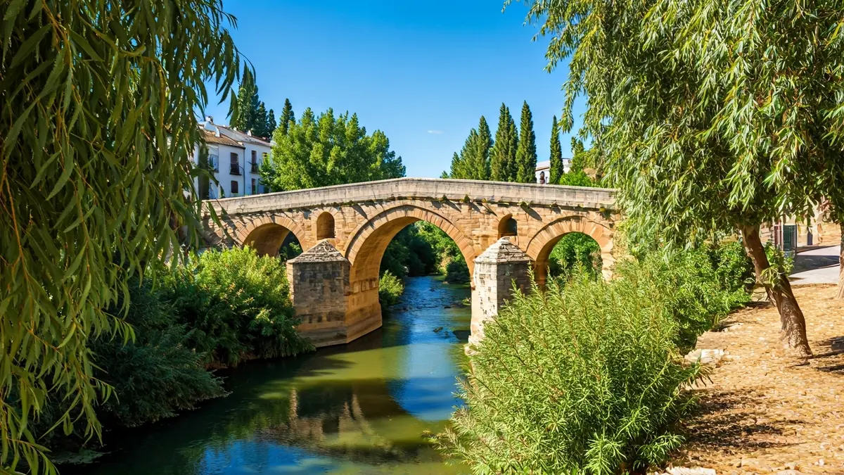 Roman Bridge of Villa del Río, a historic monument connecting Andalusian provinces.
