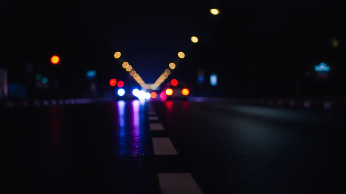 Generic image of emergency lights reflecting on wet asphalt.