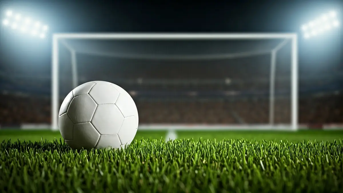 Generic image of a soccer ball on a stadium pitch.