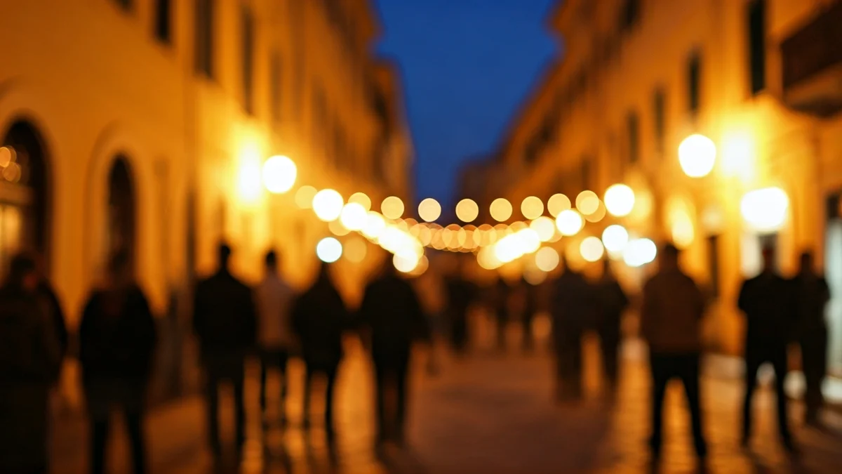 Generic image of a bustling street in a Mediterranean city at night, with warm lights and traditional architecture.