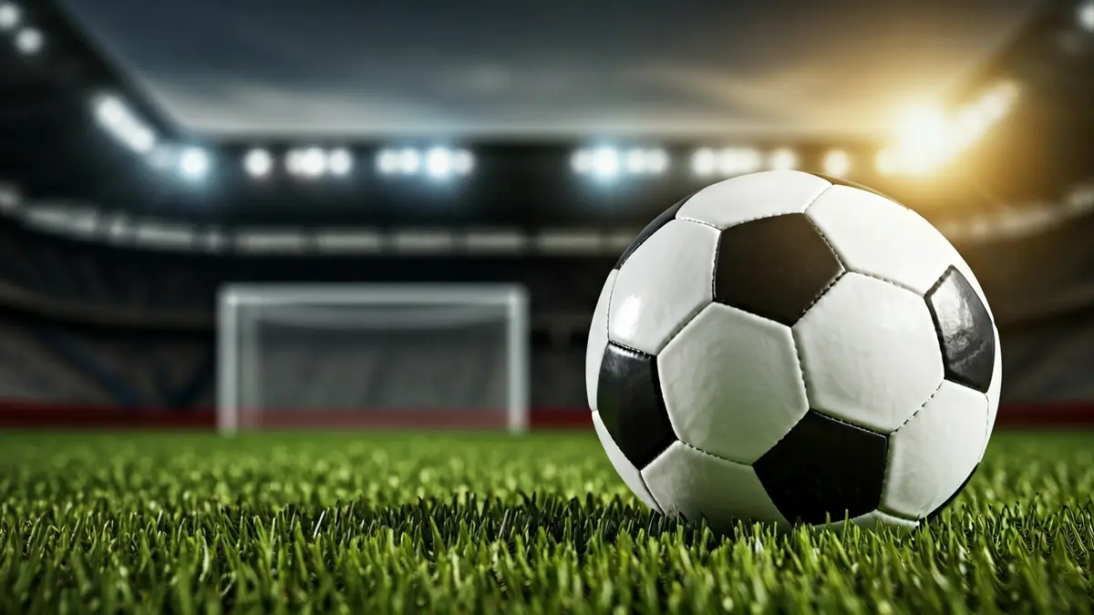 Generic image of a soccer ball on a stadium pitch.