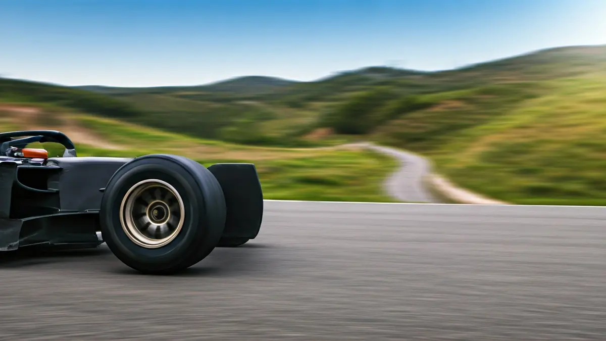 Image of a racing car tire on asphalt, with an Andalusian landscape in the background.