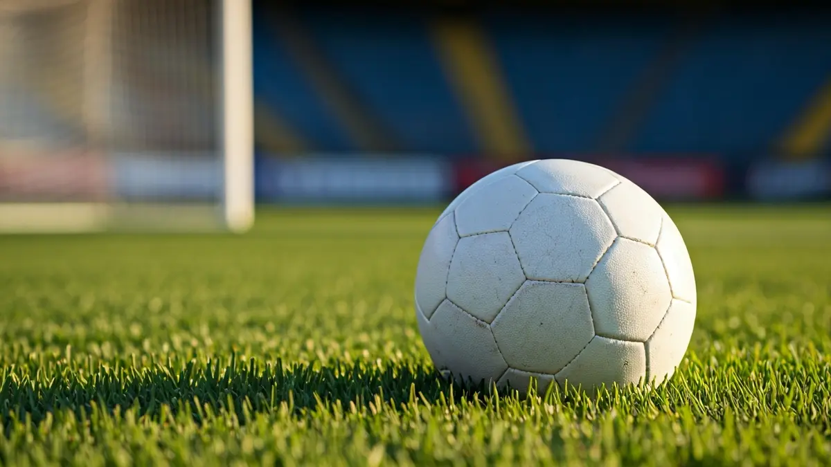 Generic image of a soccer ball on a stadium pitch.