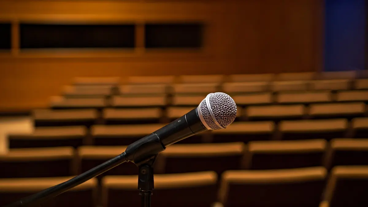 Generic image of a podium with a microphone in an auditorium, evoking a cultural event.