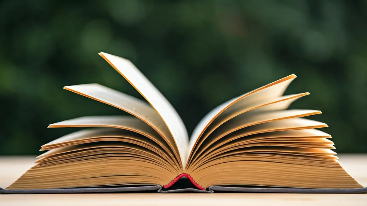 Imagen genérica de un libro abierto sobre una superficie de madera, con luz suave.