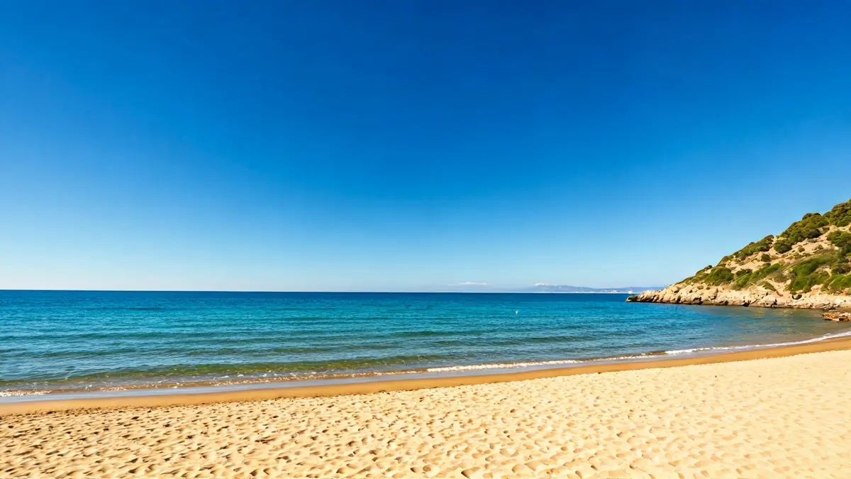 Generic image of a tranquil beach with golden sand and crystal-clear water, surrounded by nature.