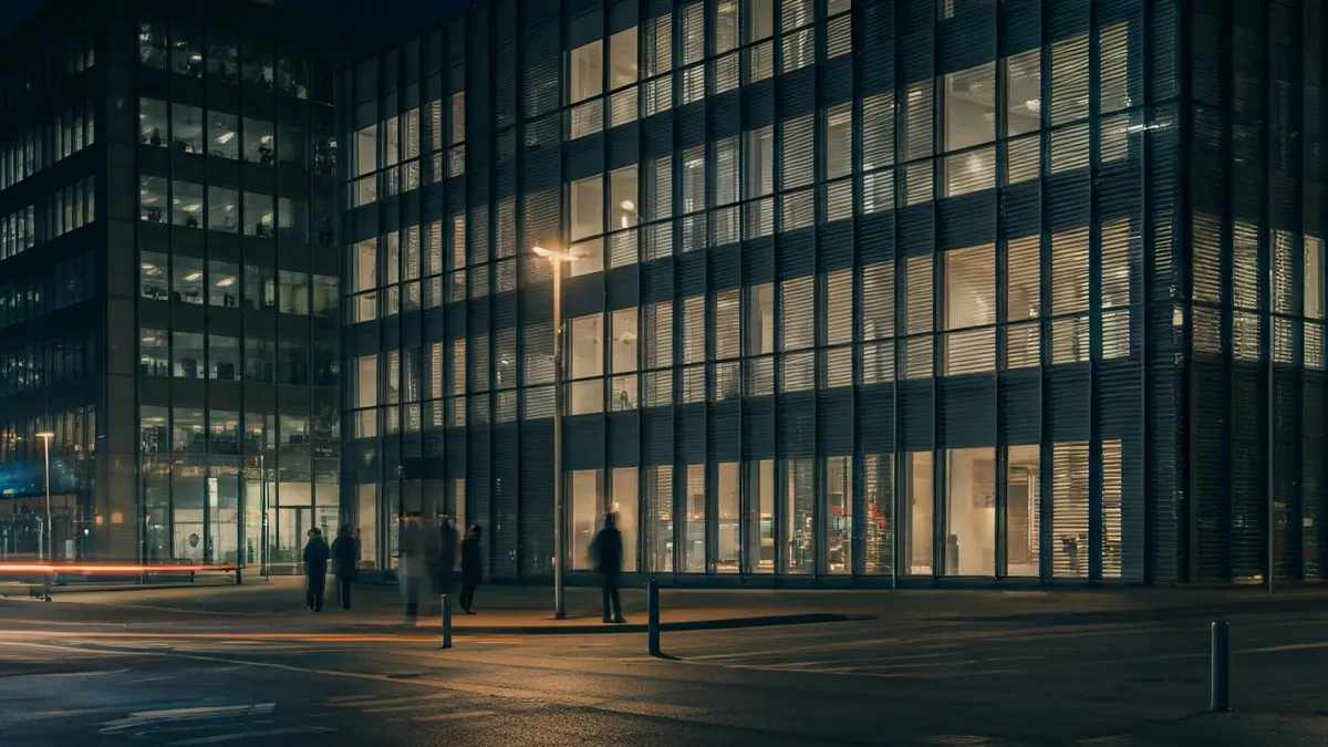 Generic image of a modern office building facade, reflecting city lights, with legal documents in the foreground.