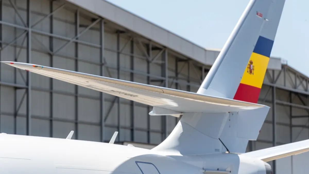Close-up of an Airbus C295 aircraft wing with the Spanish flag on the tail, at the Sevilla plant hangar.