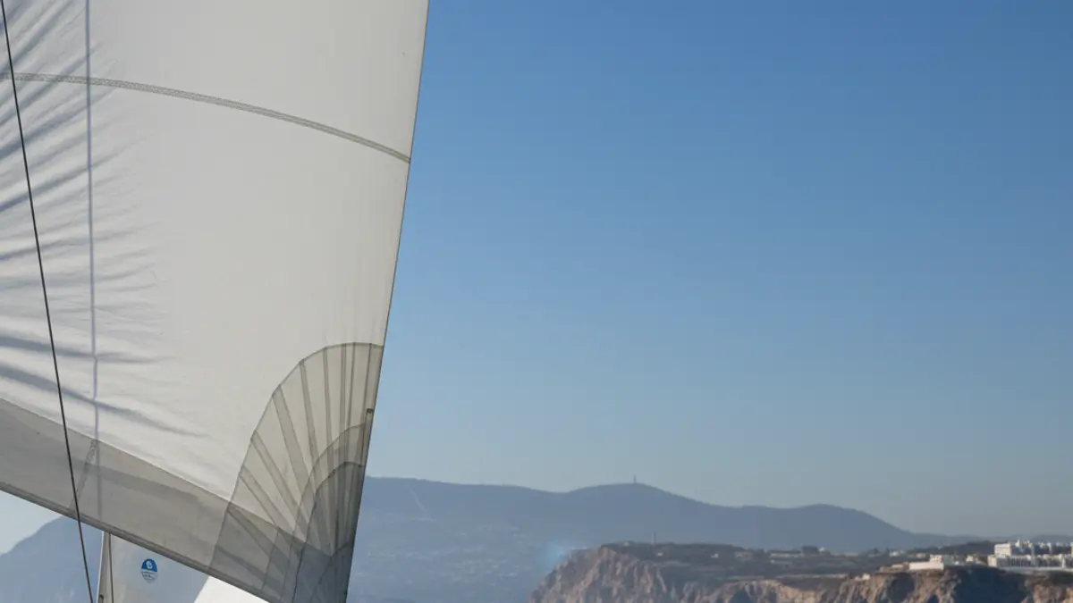 Image of a sailboat navigating in the Strait of Gibraltar during a regatta.