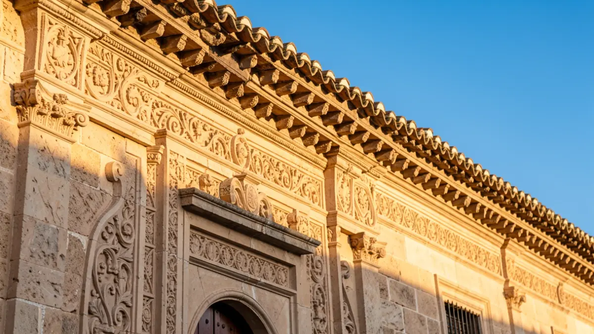 Facade of a historic building with ornate architectural details in the warm afternoon sunlight.