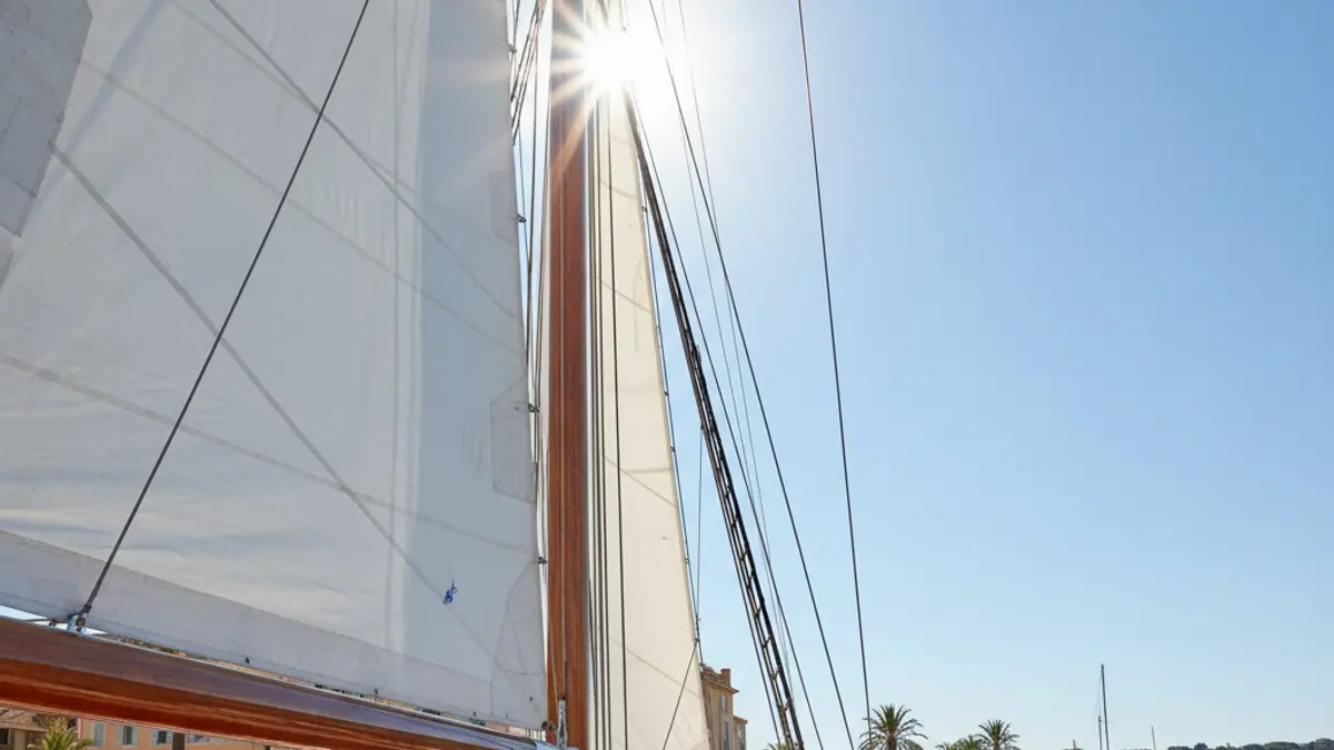Generic image of a sailboat mast against a blue sky.