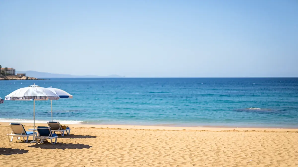 Generic image of a Mediterranean beach in Malaga with umbrellas and the sea.