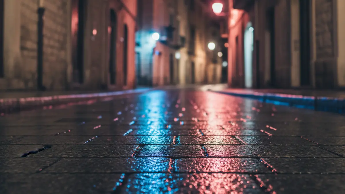 Generic image of emergency lights reflected on wet asphalt.