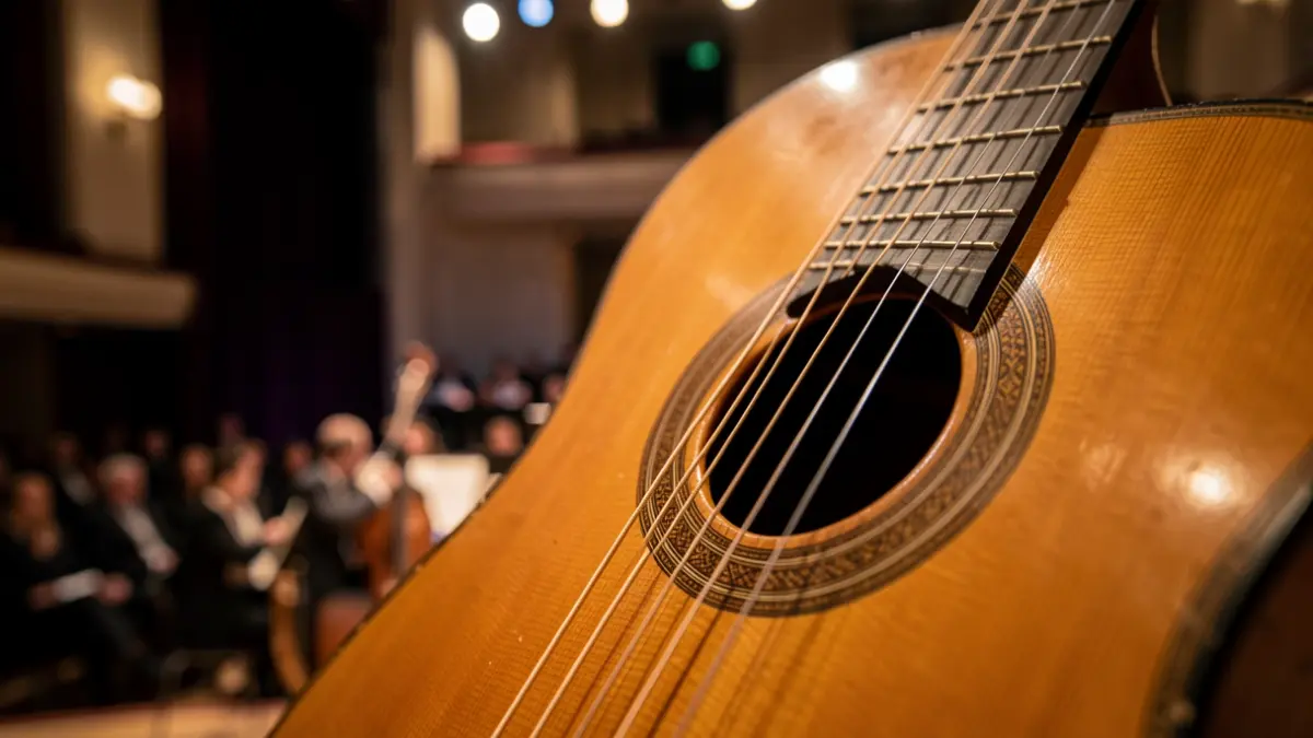 Close-up of a classical guitar's soundhole and strings, with a blurred background of a concert hall stage.