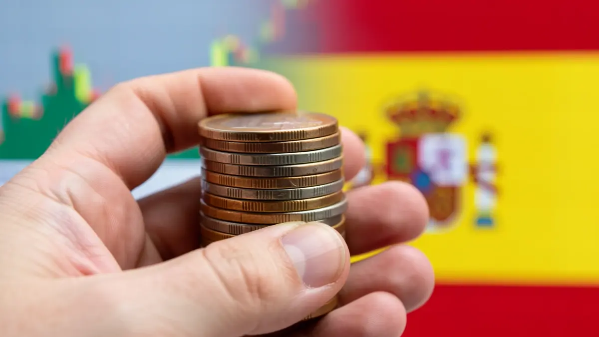 Generic image of euro coins and a financial chart with Andalusian motifs.