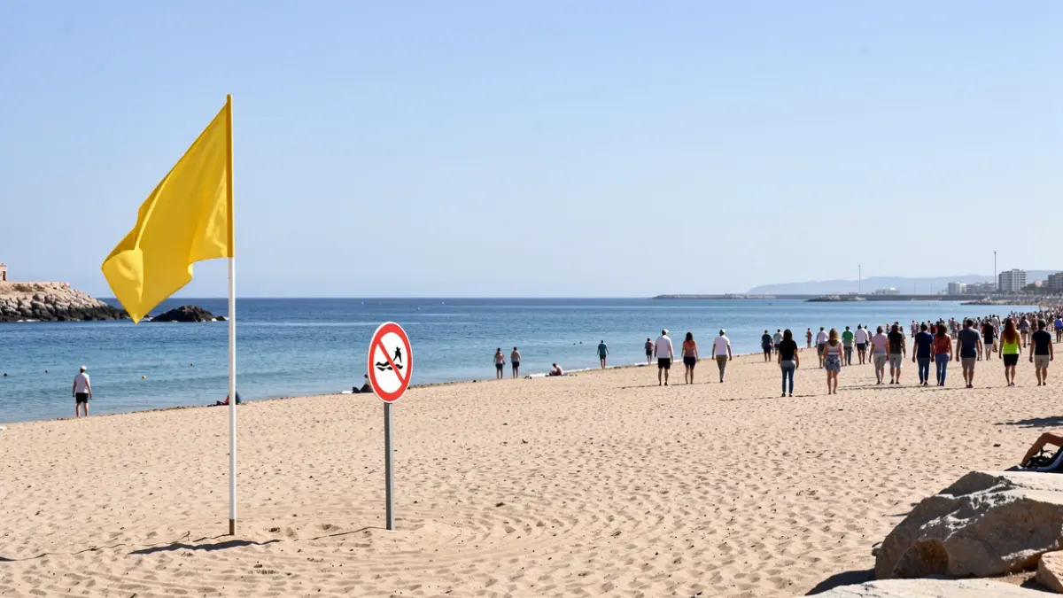 Yellow flag and no swimming sign on Atlanterra beach, Tarifa.