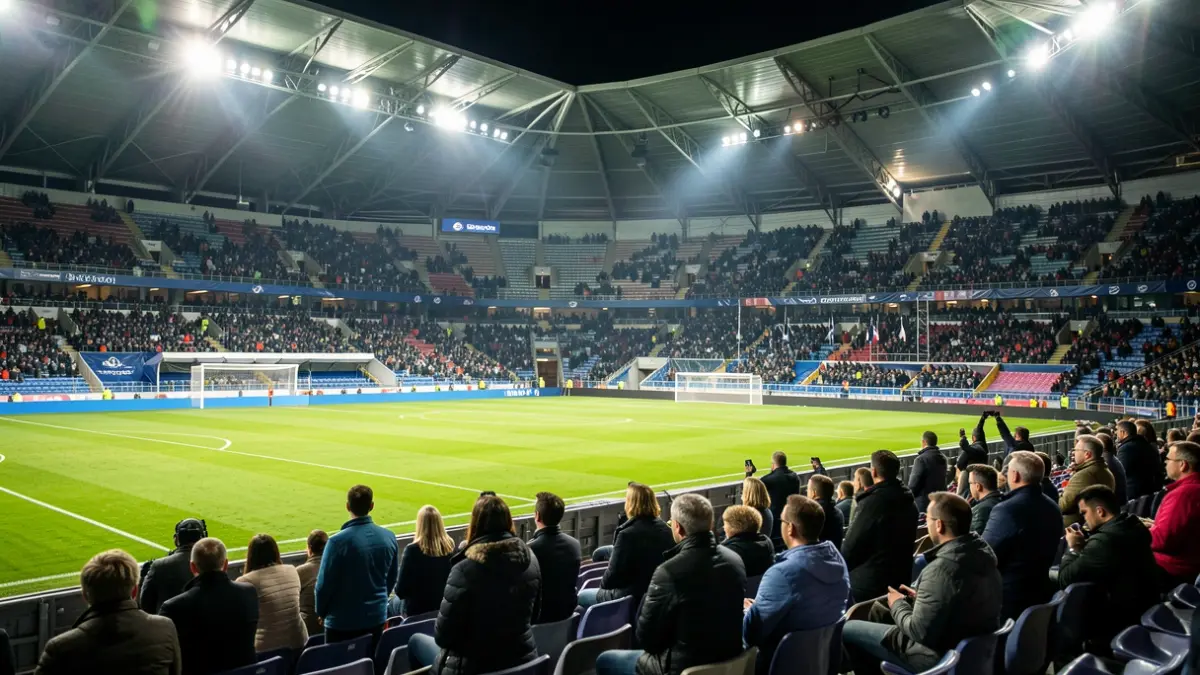 Imagen genérica de un estadio de fútbol vacío con iluminación dramática.