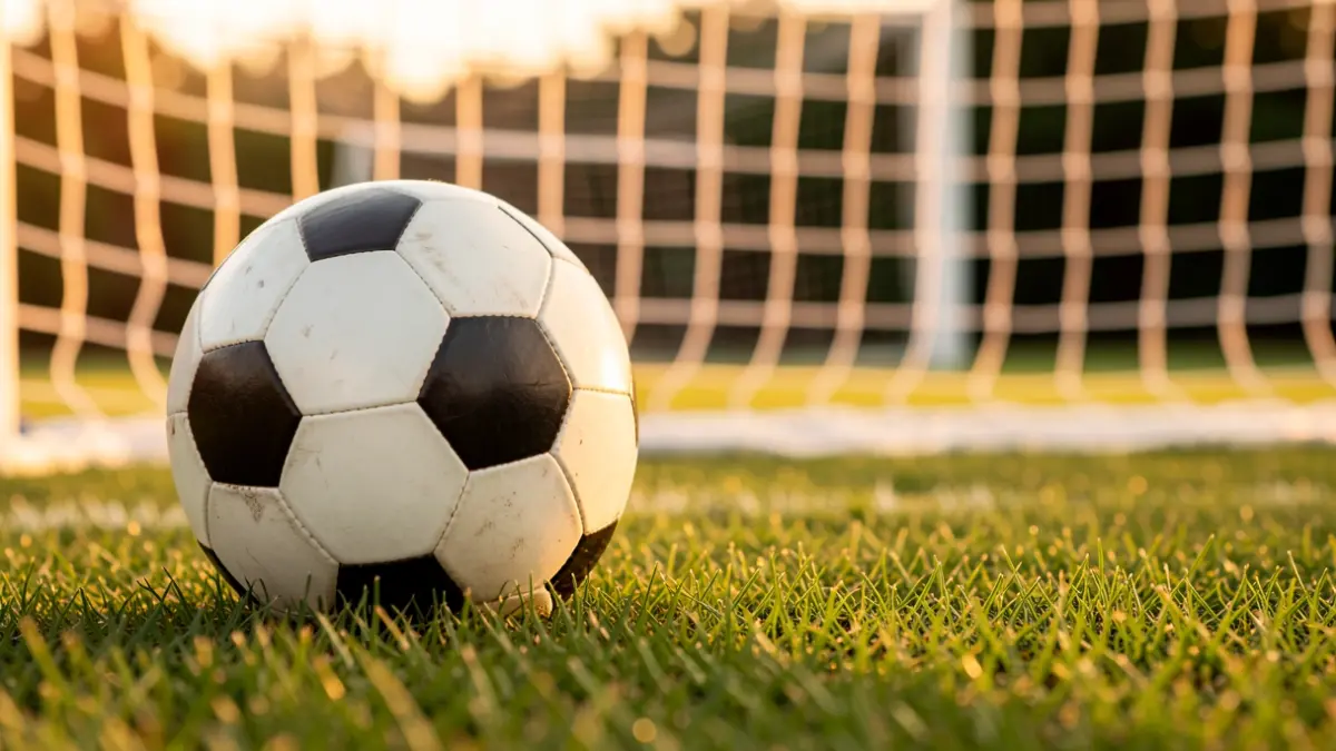 Generic image of a soccer ball on a stadium pitch.
