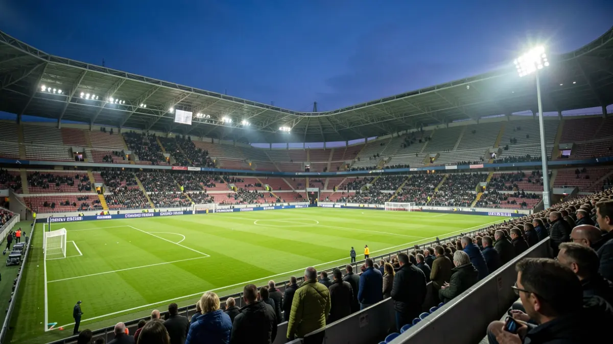 Generic image of a football stadium at dusk with lights on.