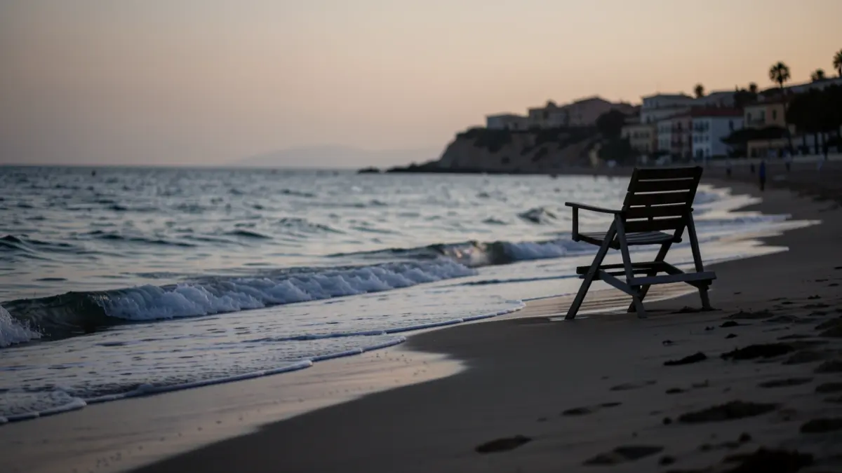 Generic image of a Mediterranean beach at sunset with an empty lifeguard chair.
