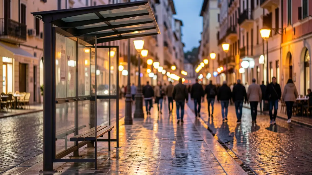 Generic image of a bus stop with wet pavement at dusk.