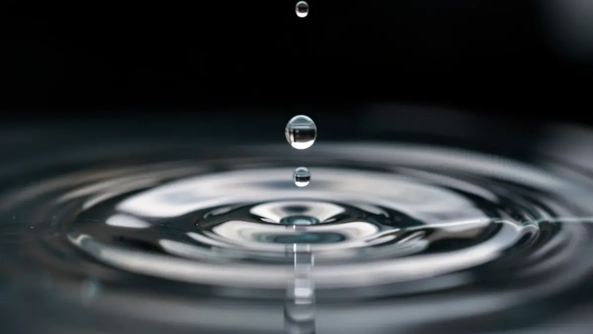 Generic image of a water droplet falling and creating ripples in water.