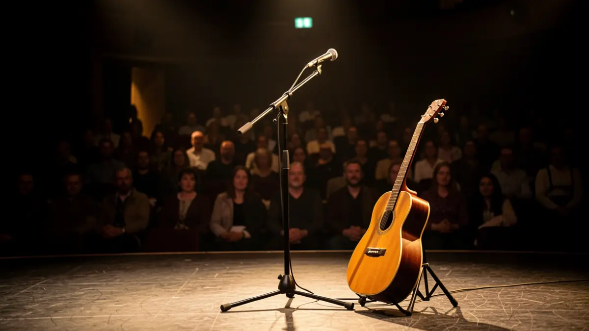 Intimate theatre scene with microphone and guitar.