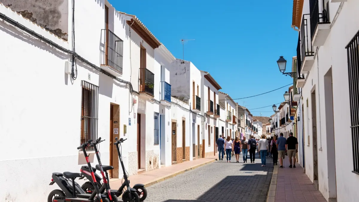 Generic image of a white Andalusian town with electric scooters parked.